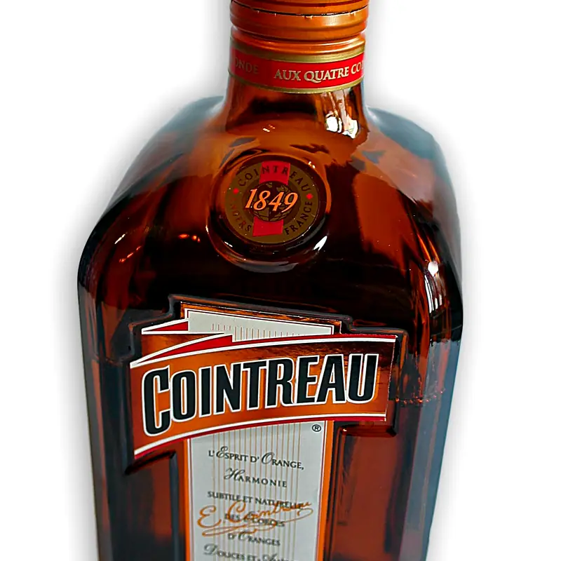 A bottle of Cointreau orange liqueur, its neck and shoulder in close view