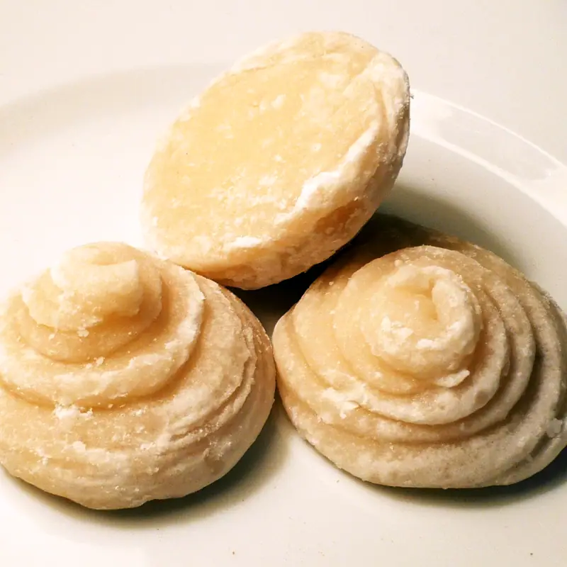 Round discs of pale golden palm sugar on a plate