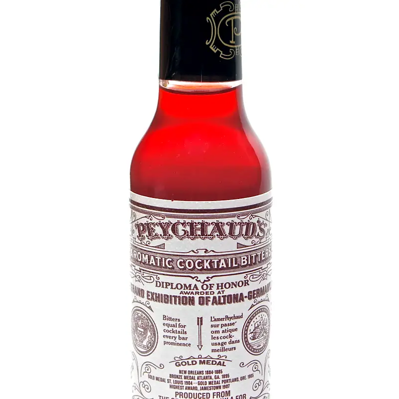 A small bottle of Peychaud's Aromatic Cocktail Bitters, deep red, against a plain white background
