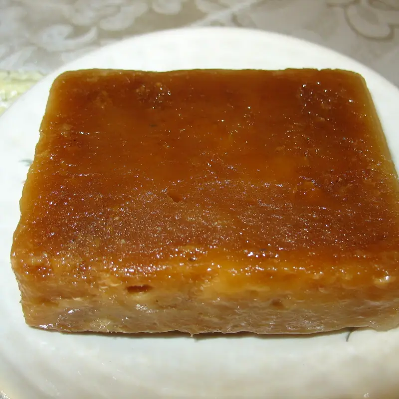 A solid amber block of piloncillo unrefined cane sugar