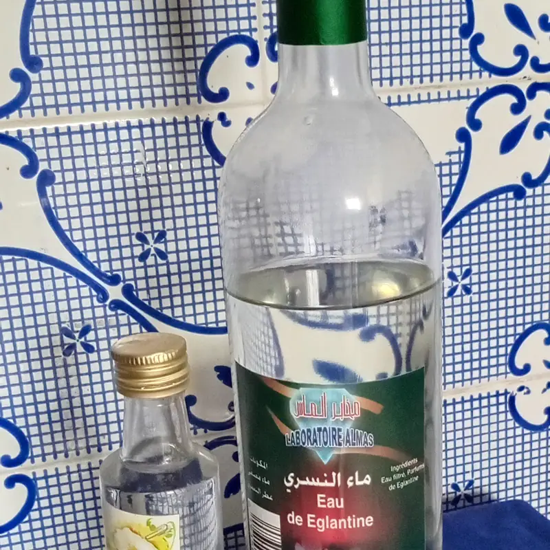 Bottles of clear rose water (Eau de Eglantine)