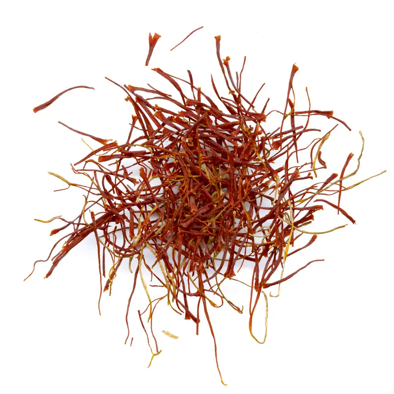 A pile of dark red-orange dried saffron threads on white
