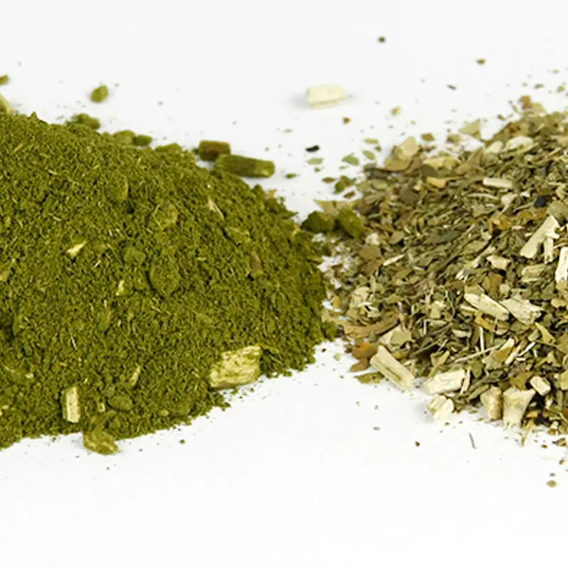 Two piles of dried yerba mate, one ground fine and one coarsely cut with stems