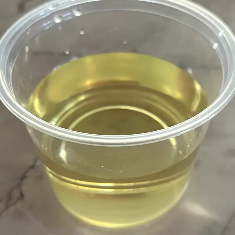 A clear, pale golden sugar syrup filling a plastic cup